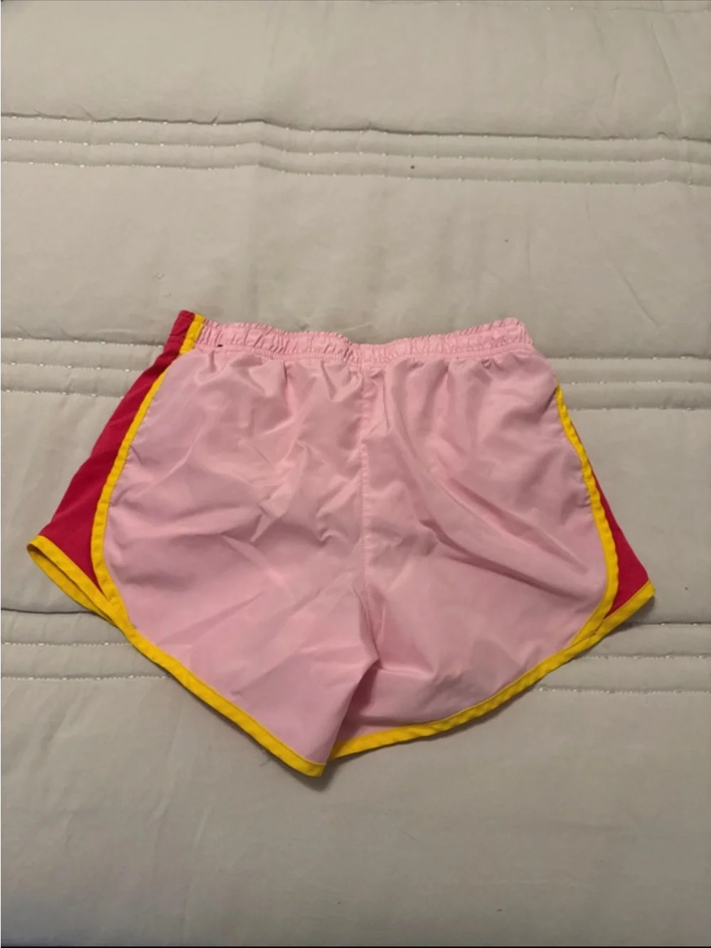 Nike Pink Shorts with Yellow Trim and Red Accents